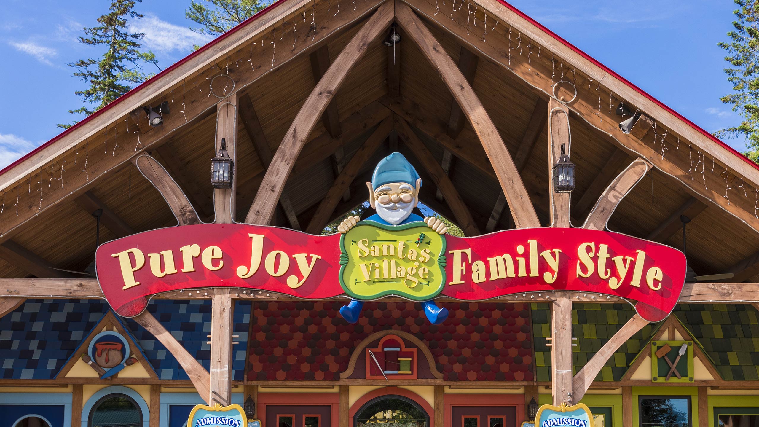 Santa's Village entrance — festive archway with colorful lights and Christmas decorations